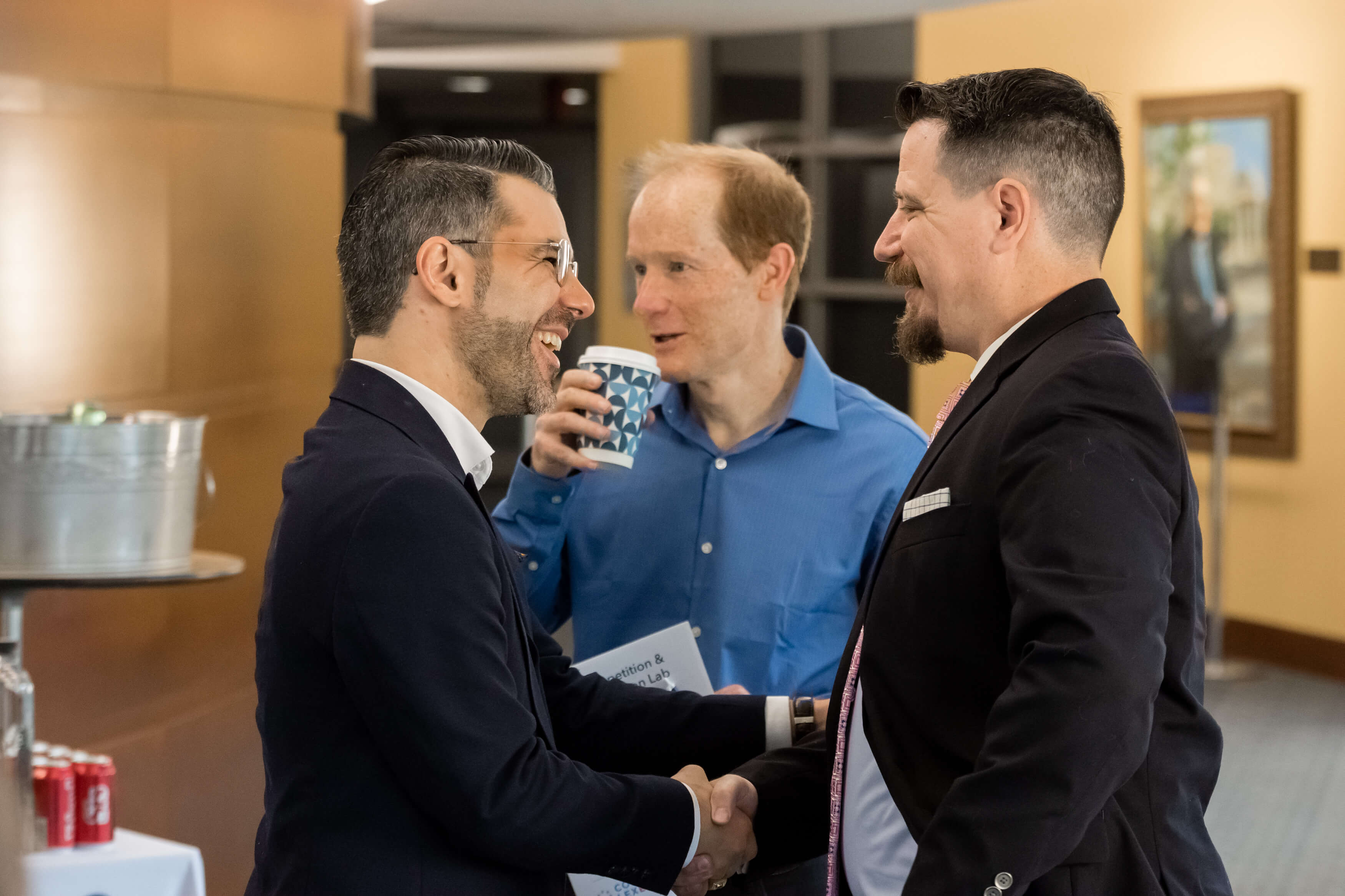 Aurelien Portuese speaks on stage with FTC commissioner, Mark Meador