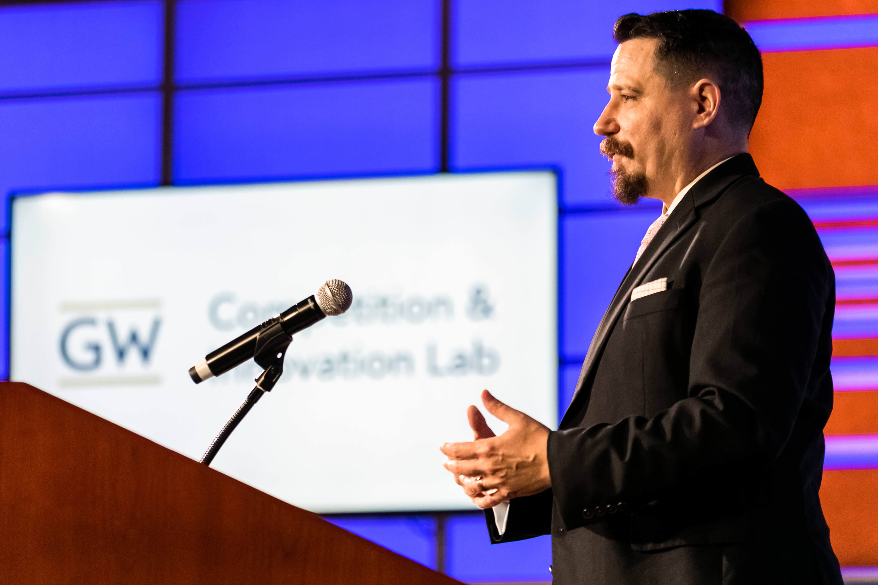 Aurelien Portuese speaks on stage with FTC commissioner, Mark Meador
