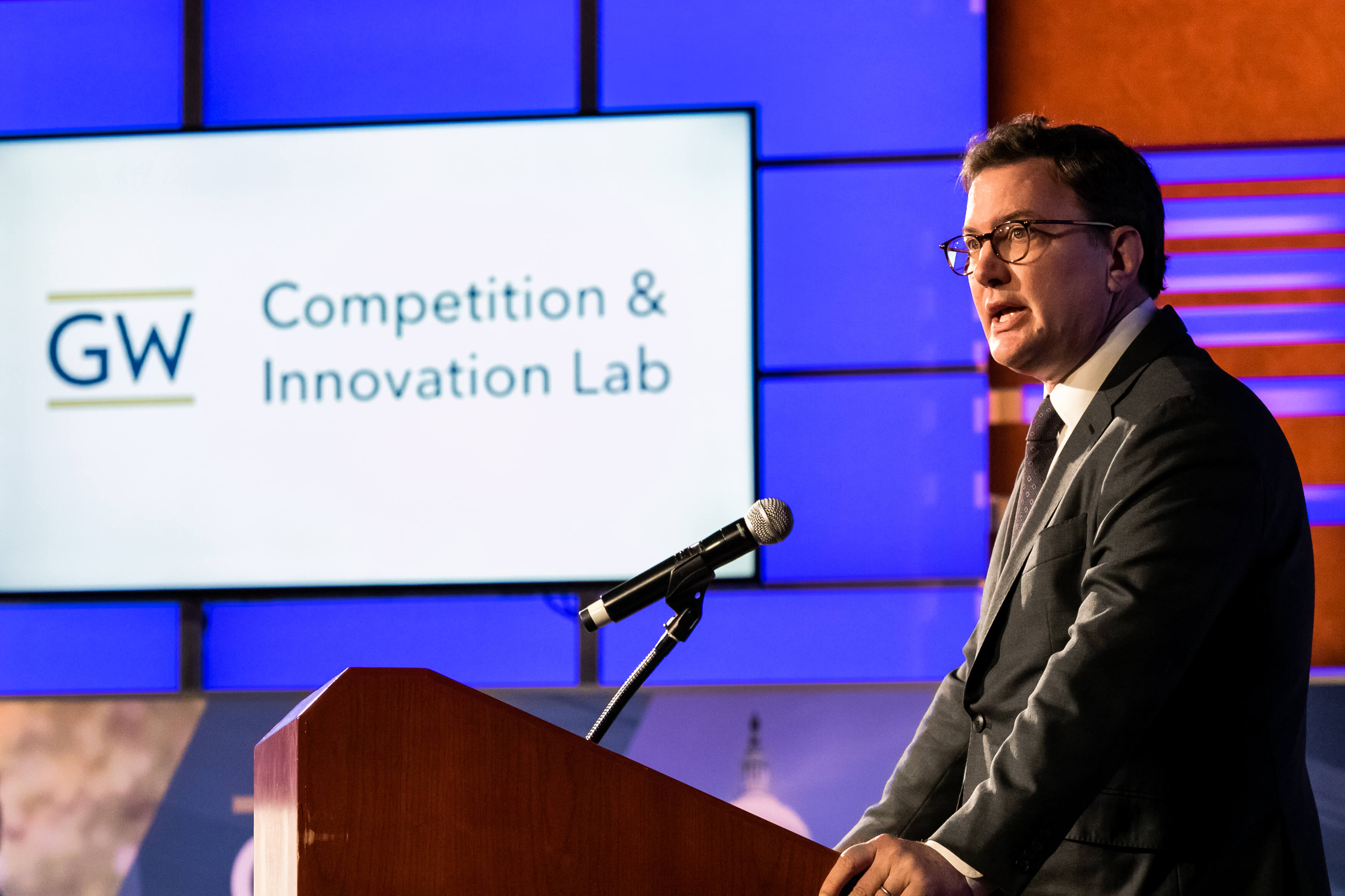 Aurelien Portuese speaks on stage with FTC commissioner, Mark Meador