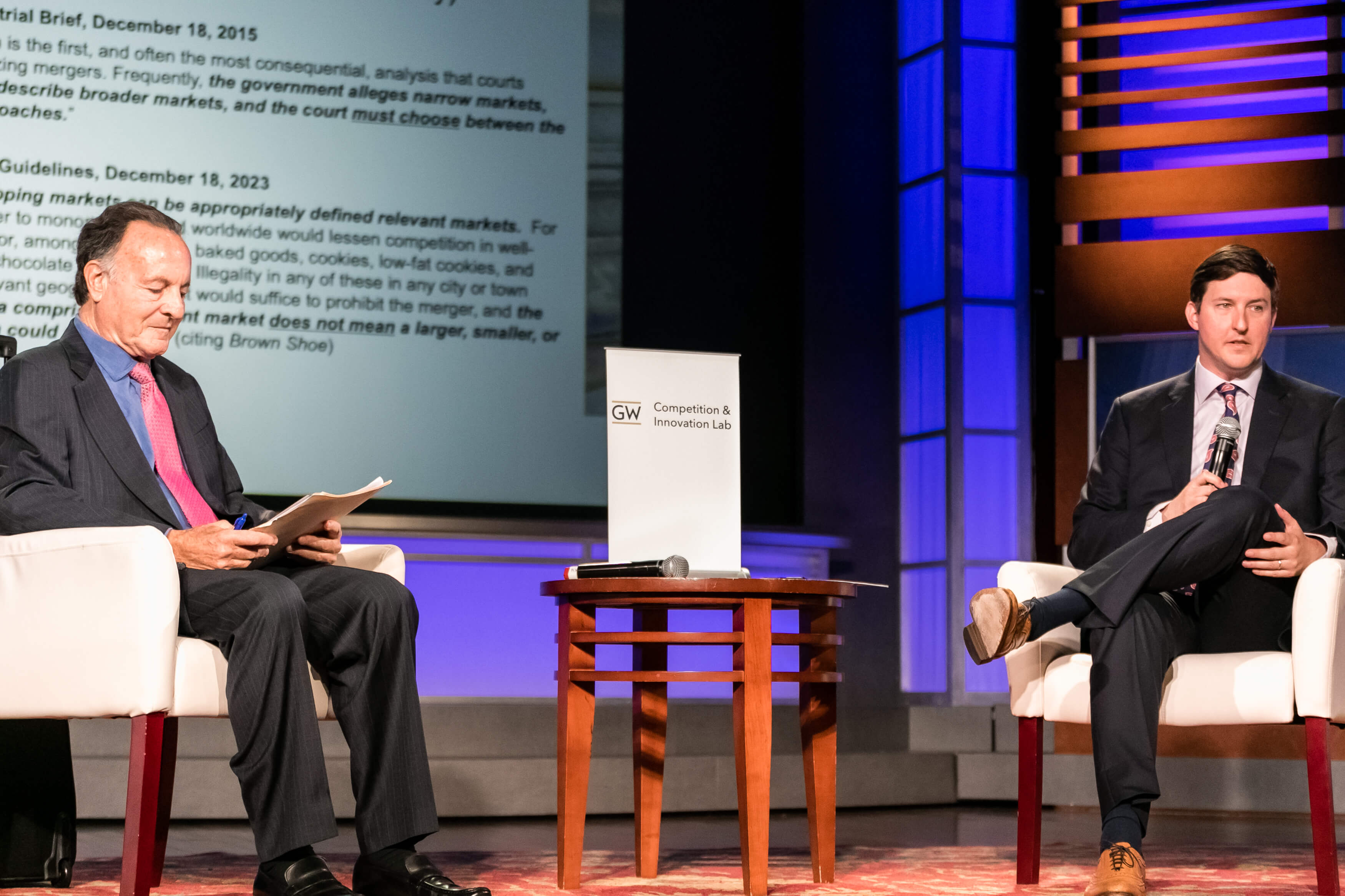 Aurelien Portuese speaks on stage with FTC commissioner, Mark Meador