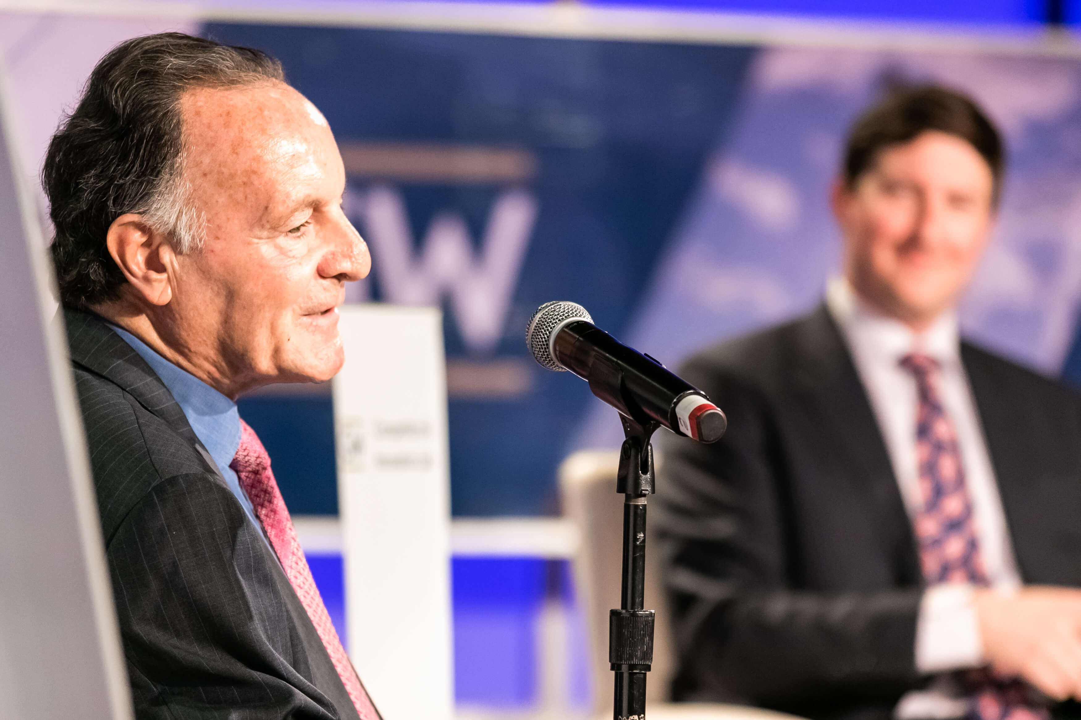 Aurelien Portuese speaks on stage with FTC commissioner, Mark Meador