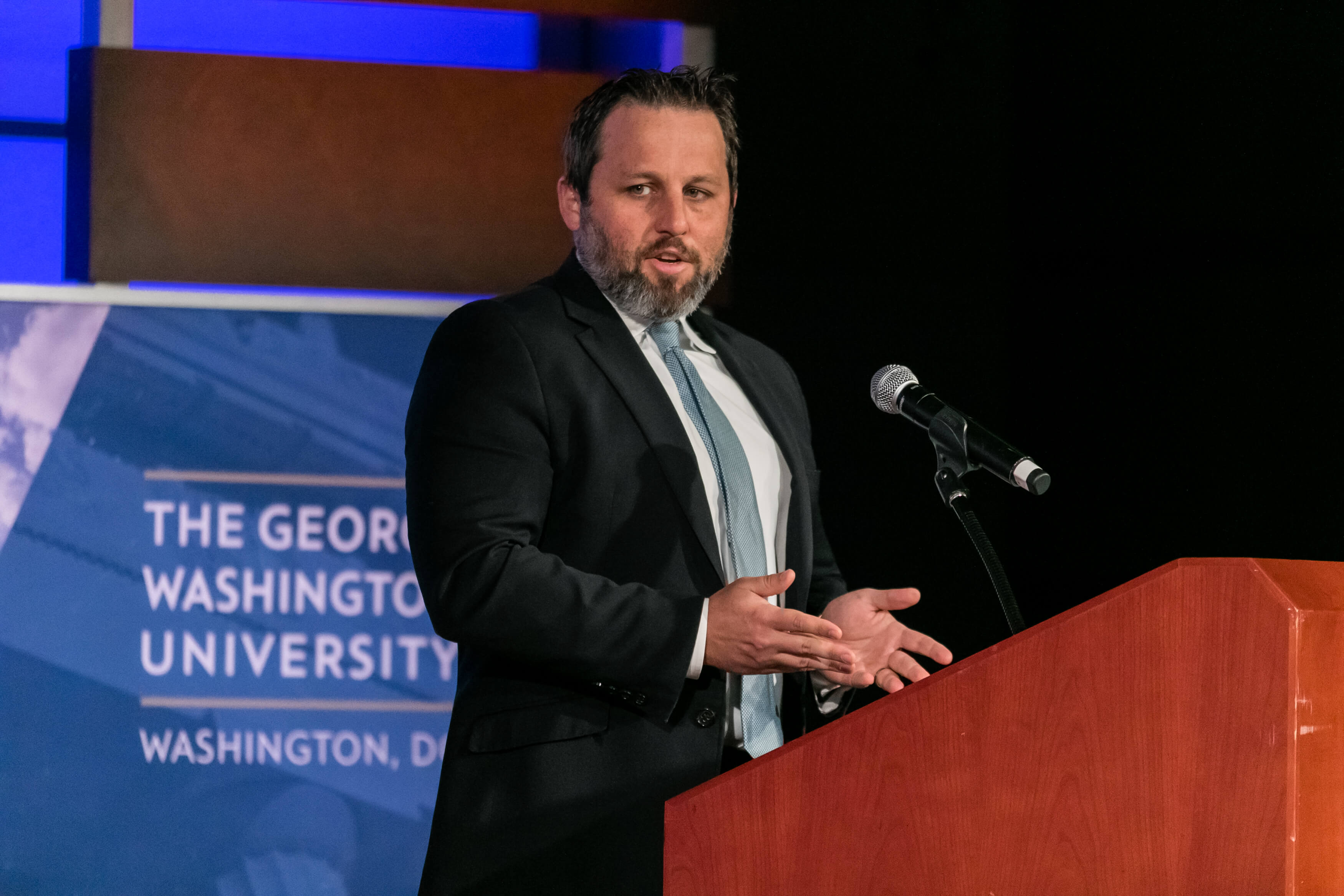 Aurelien Portuese speaks on stage with FTC commissioner, Mark Meador