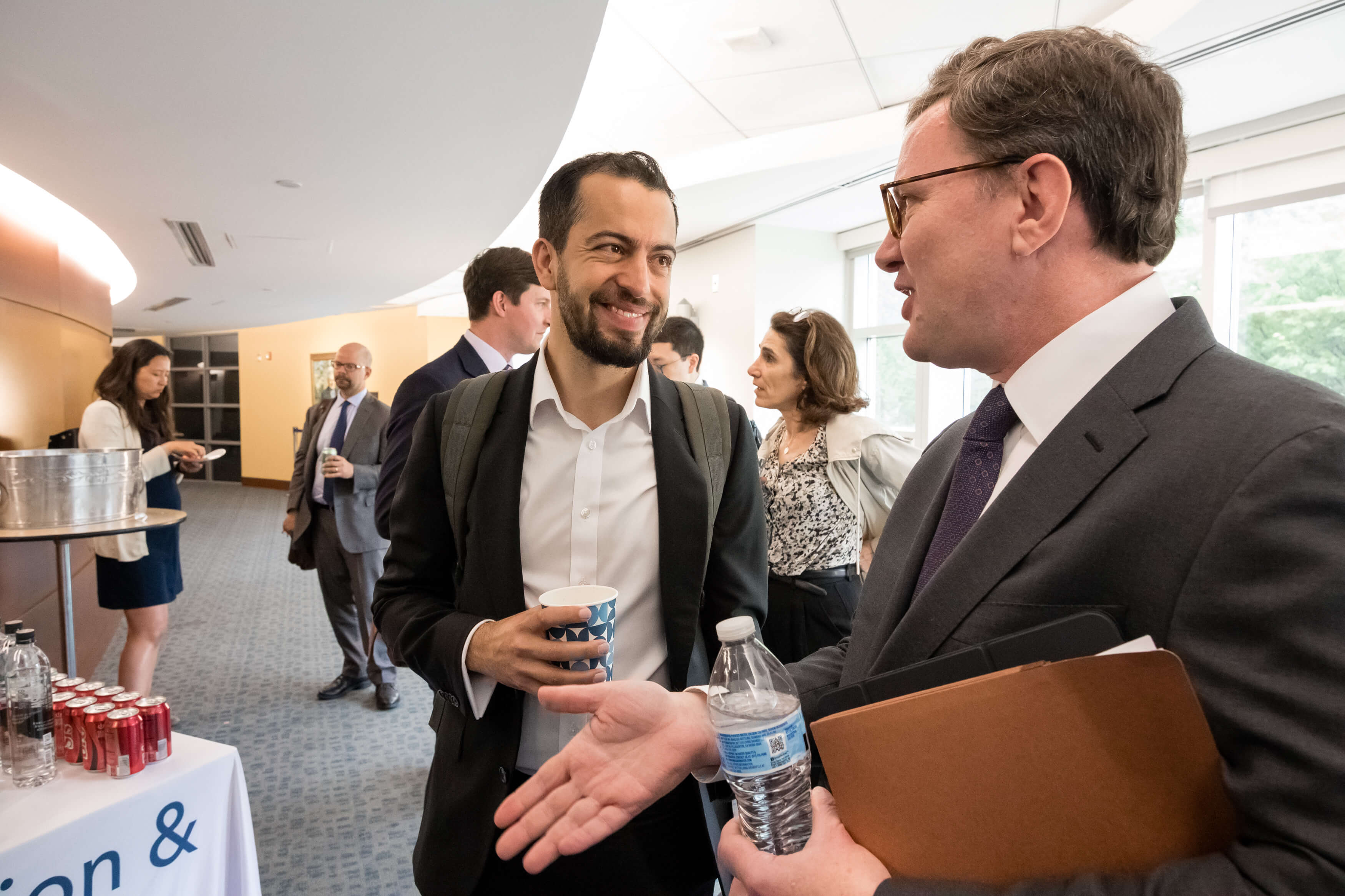 Aurelien Portuese speaks on stage with FTC commissioner, Mark Meador
