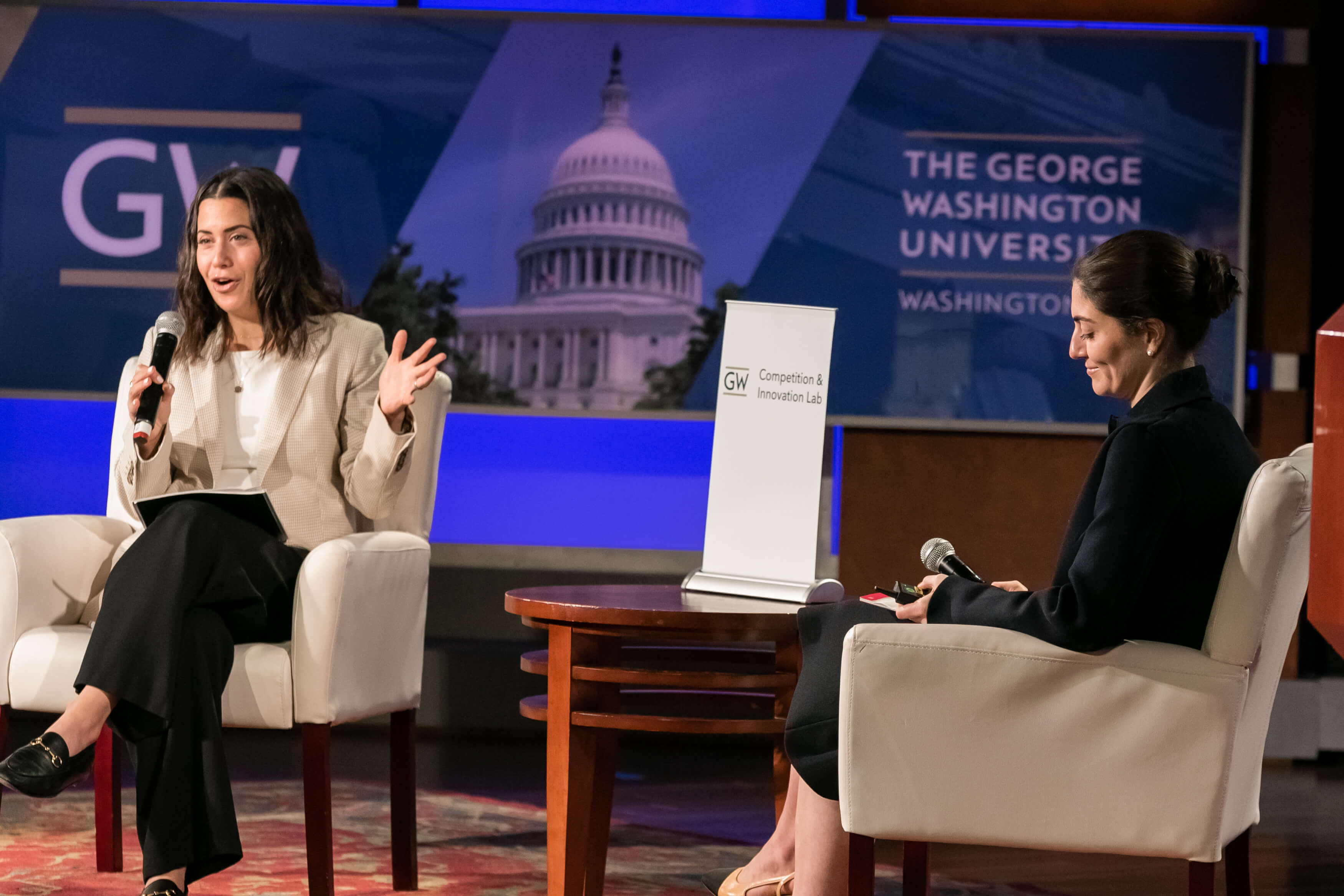 Aurelien Portuese speaks on stage with FTC commissioner, Mark Meador