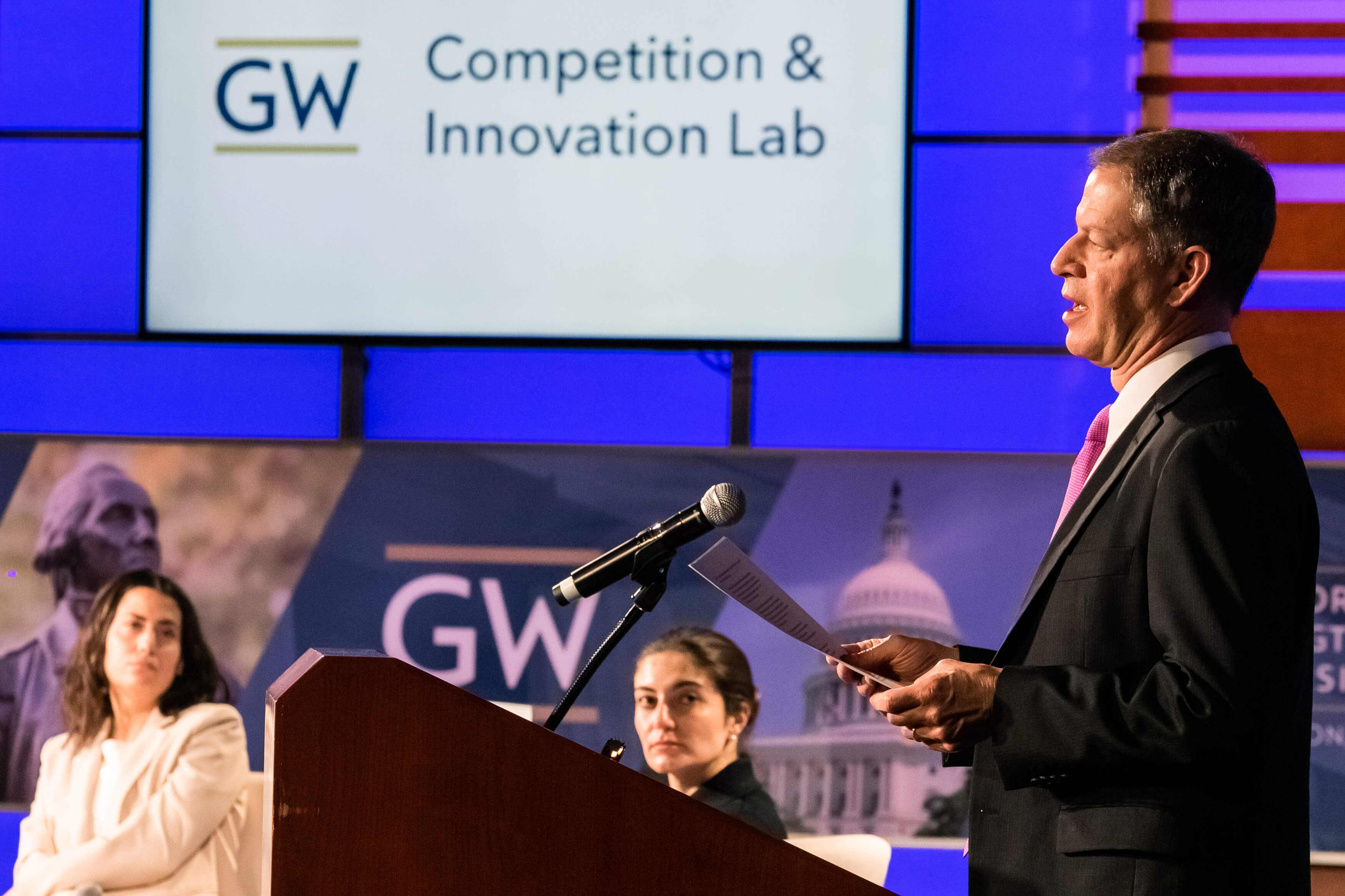 Aurelien Portuese speaks on stage with FTC commissioner, Mark Meador