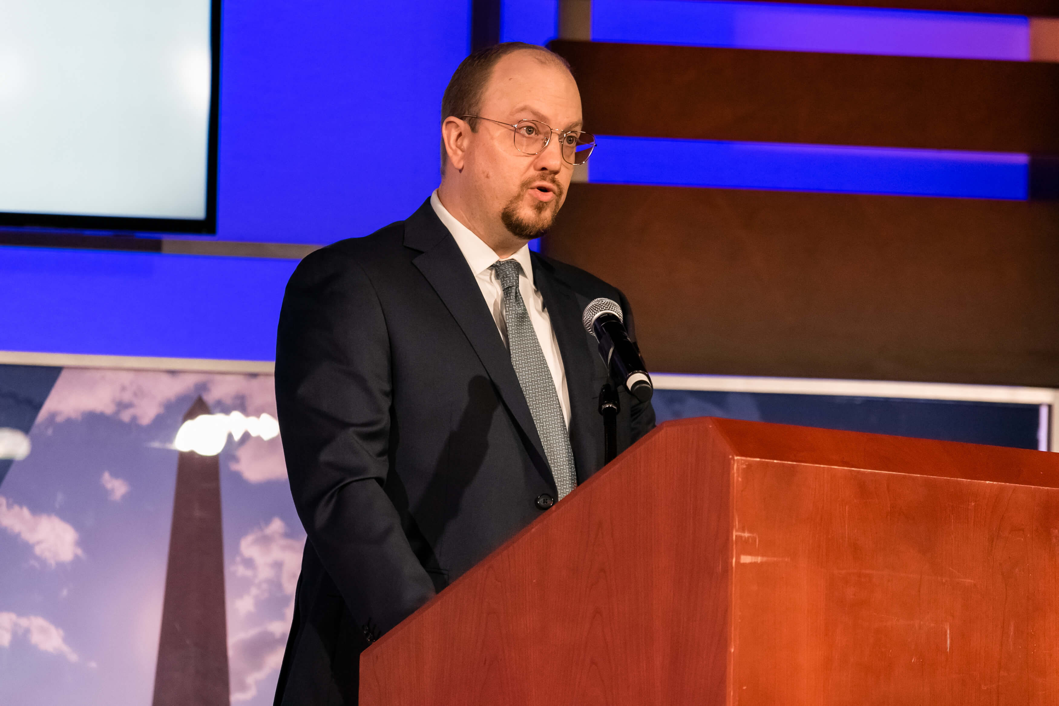 Aurelien Portuese speaks on stage with FTC commissioner, Mark Meador