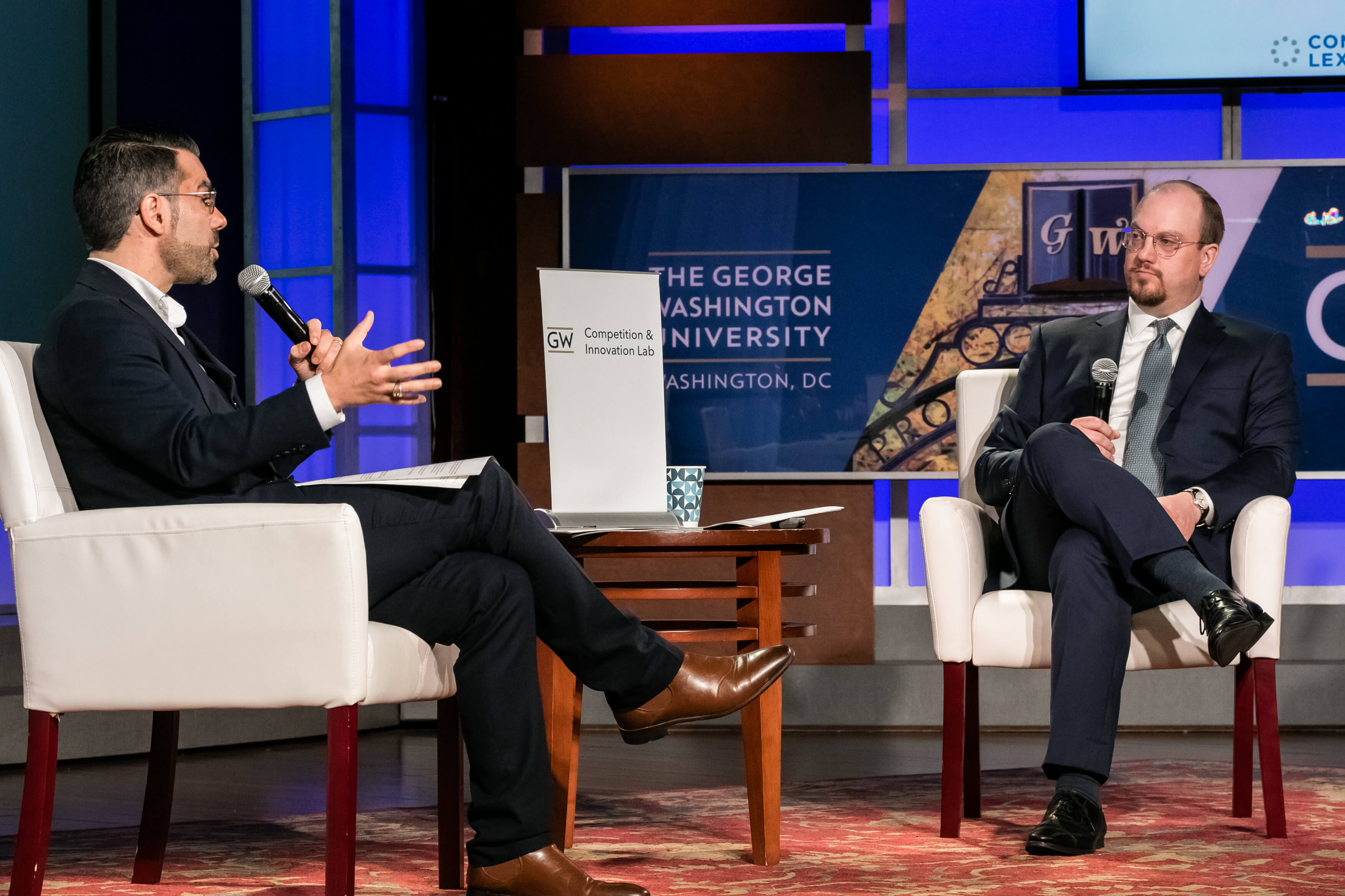 Aurelien Portuese speaks on stage with FTC commissioner, Mark Meador