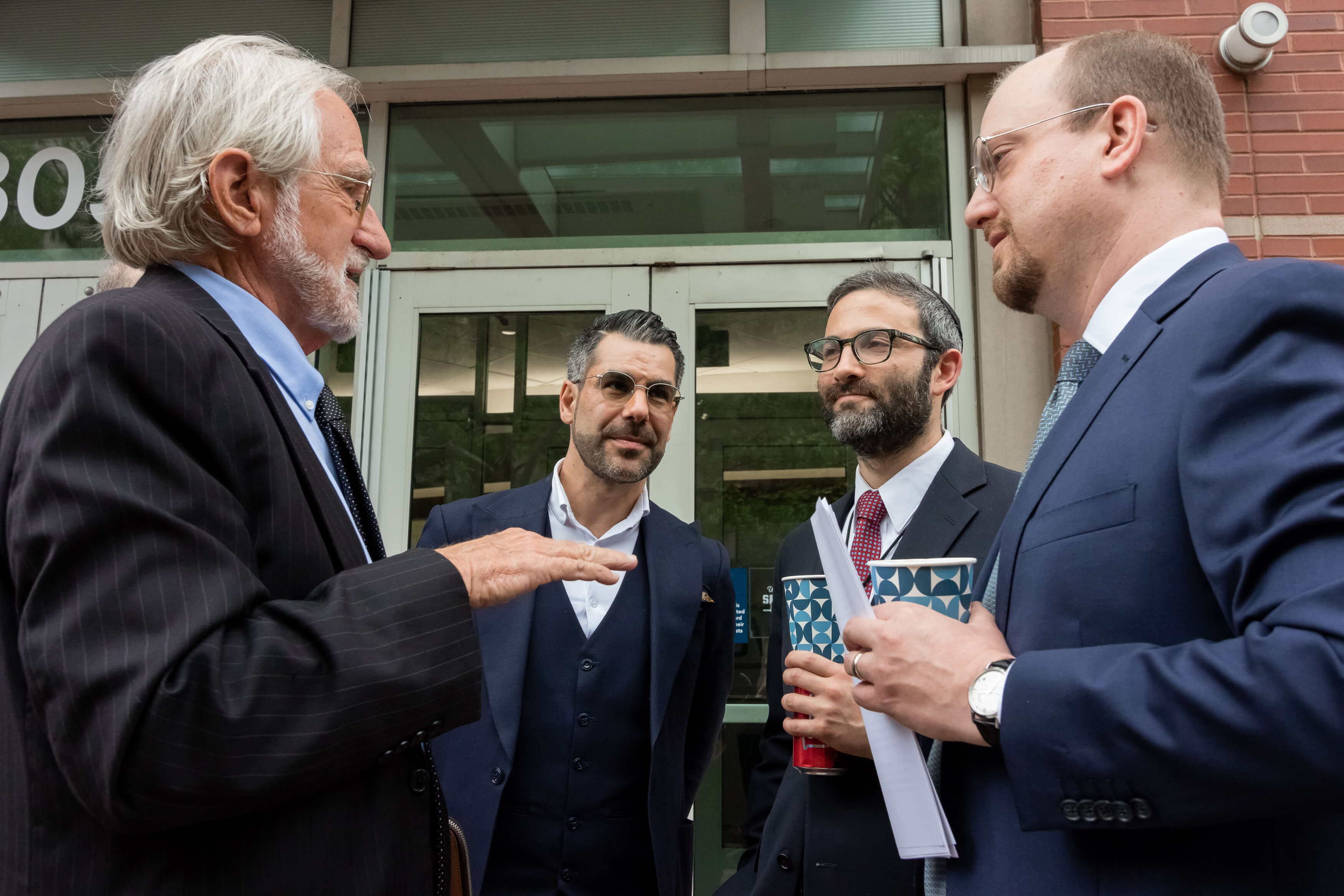 Aurelien Portuese speaks on stage with FTC commissioner, Mark Meador