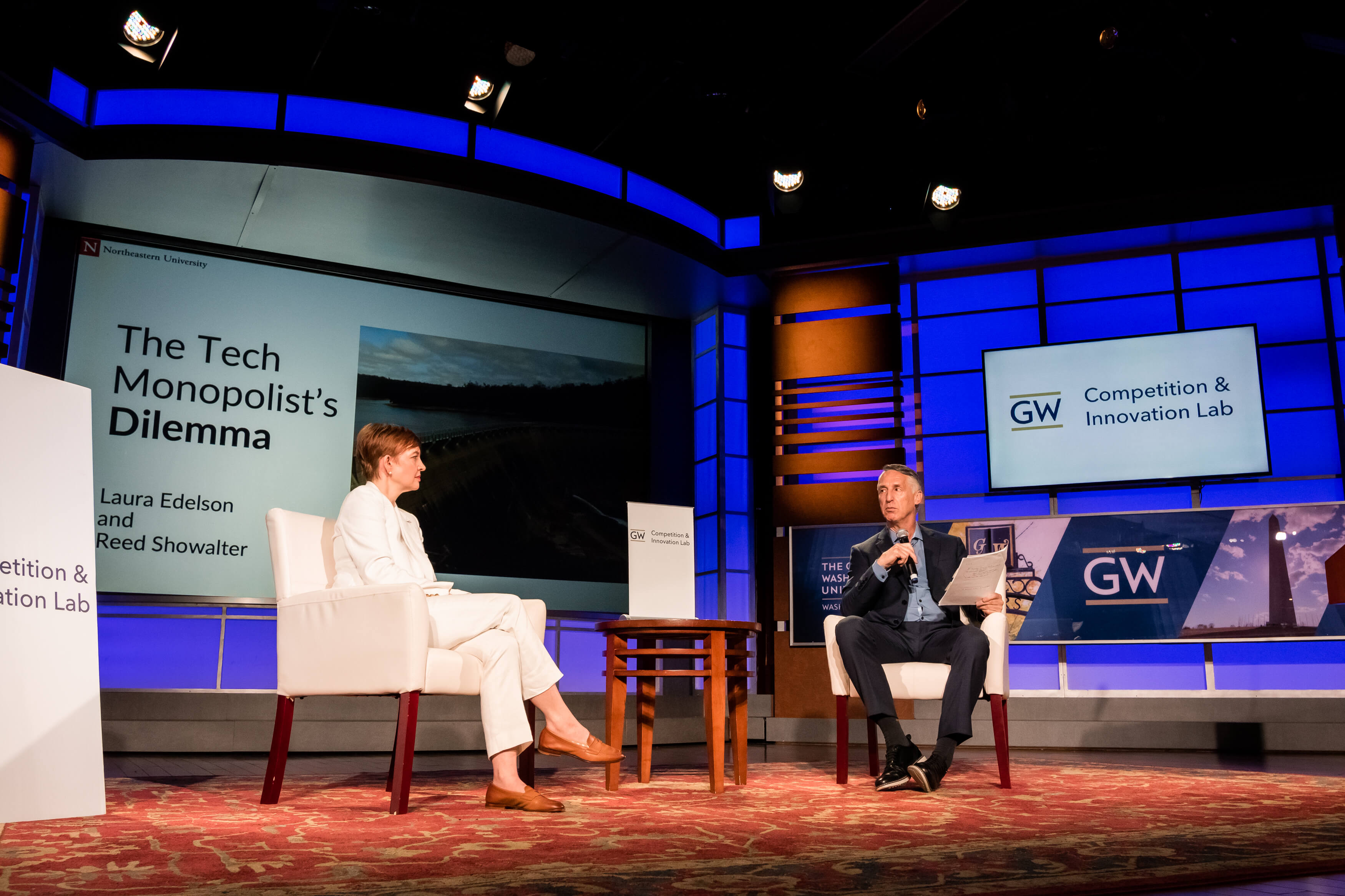 Aurelien Portuese speaks on stage with FTC commissioner, Mark Meador