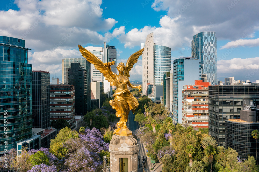 Image of Mexico City skyline with golden angel statue in foreground