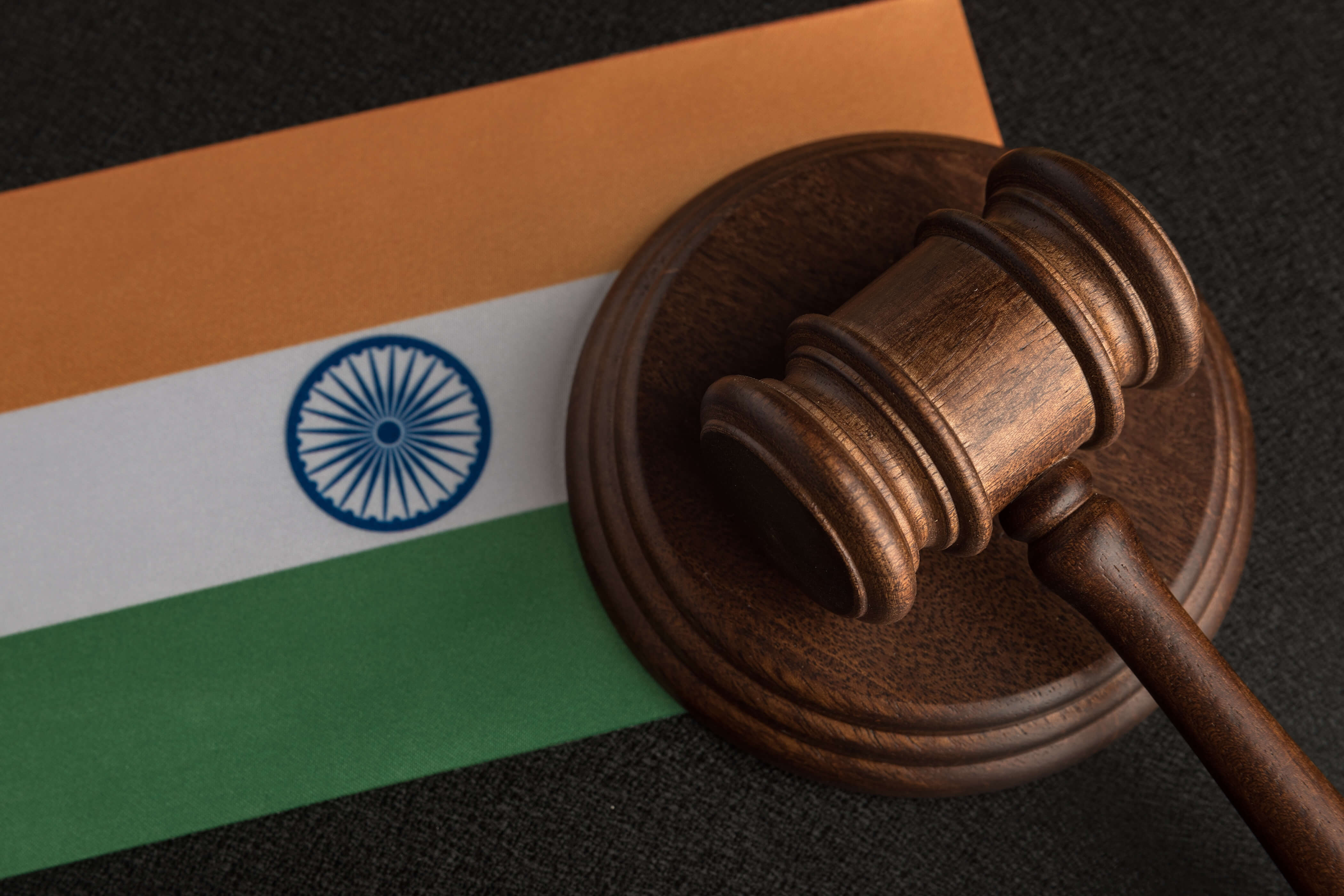 A gavel resting on the India flag