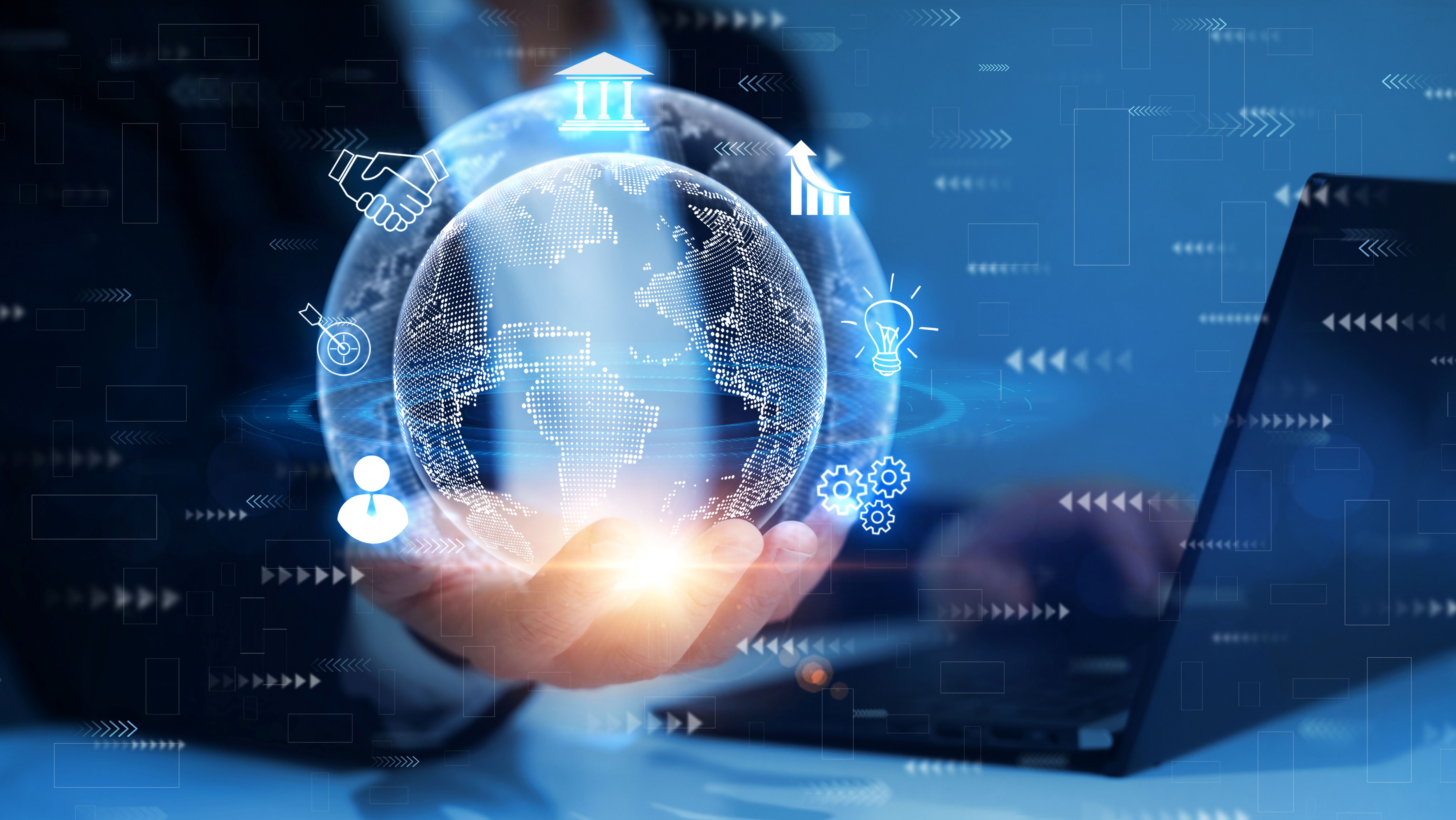 A hand holds out a digital globe surrounded by icons representing globalization and an interconnected world