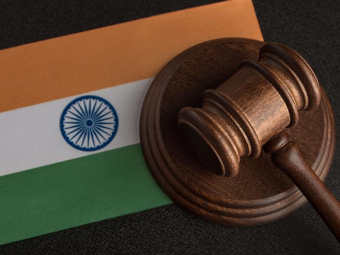 A gavel resting on the India flag