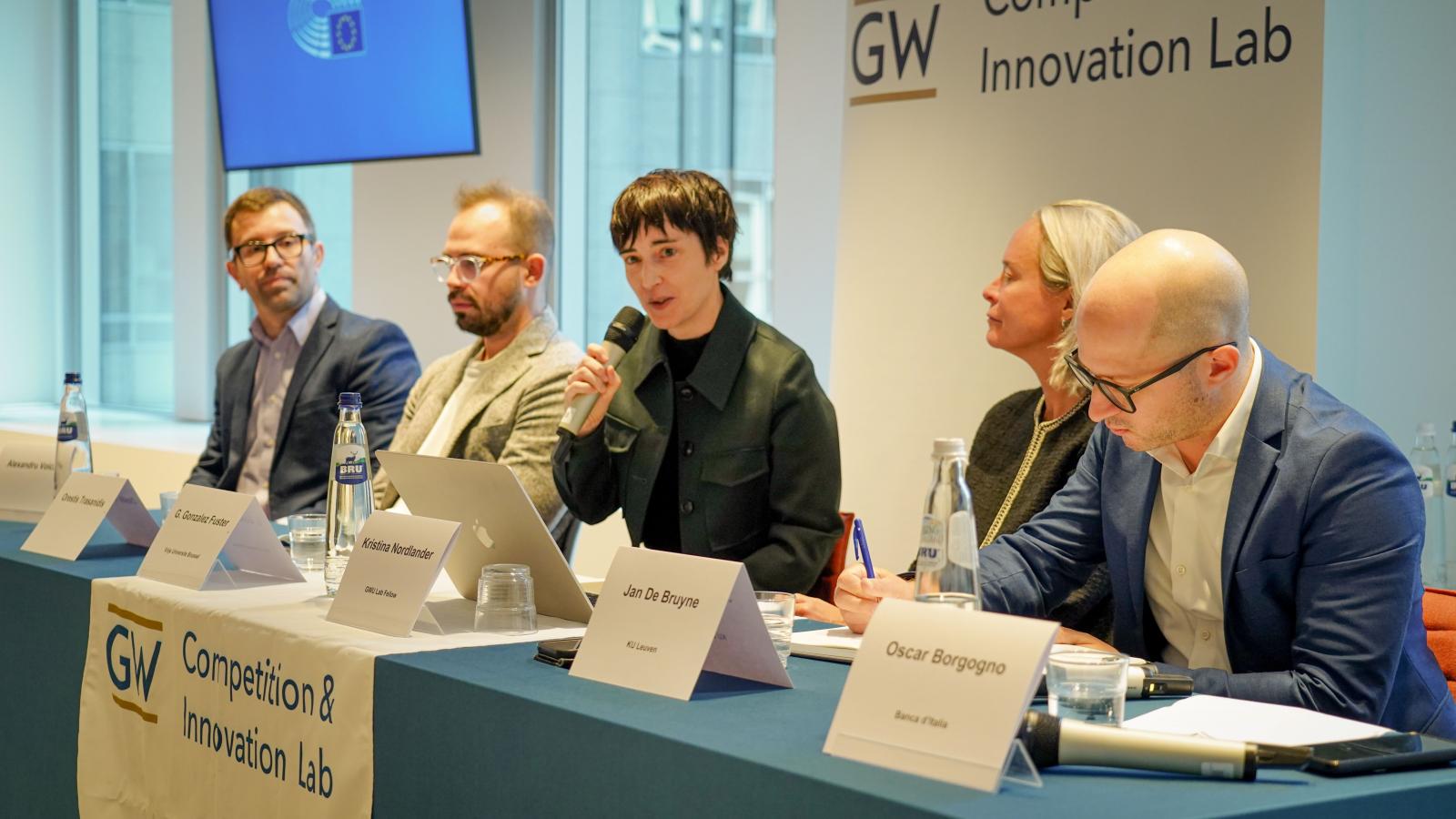 3 men and 2 women present on a panel at a conference